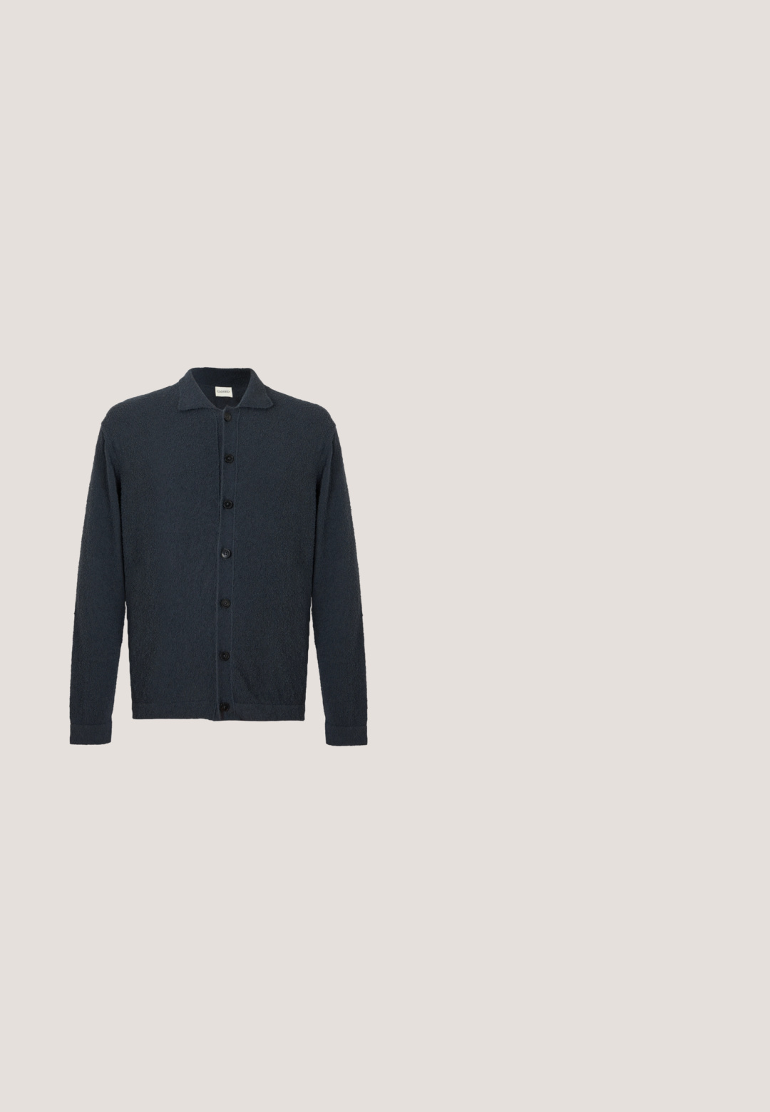 Dark navy blue button-up cardigan with long sleeves, collar, and textured fabric, displayed on a plain white background.; Light green sleeveless quilted vest with snap buttons and geometric chevron stitching pattern, label visible inside neck area.; Light pink cotton t-shirt with short sleeves and round neckline. Features "DAD" printed in a darker shade on the left chest.; Khaki trousers made of lightweight fabric. Features an elastic waistband, a button closure, straight legs, and a smooth texture.; Dark brown suede sneaker with white laces, beige heel tab, and light brown rubber sole viewed from the side on a plain background.; Dark brown leather crossbody bag with flap closure and adjustable fabric strap on white background.
