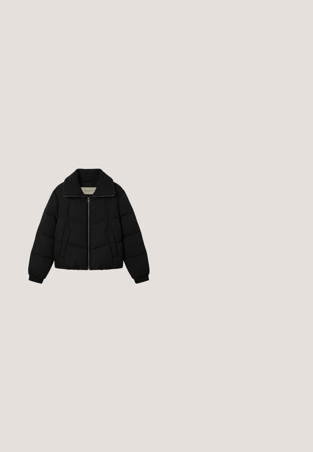 Zwarte donsjas met een geribde, brede kraag, ritssluiting aan de voorkant, zijzakken en elastische manchetten. Label toont Calvin Klein Jeans.; Zwarte Calvin Klein T-shirt met korte mouwen, ronde hals en "Calvin Klein" logo in kleine witte letters op de linkerborst.; Zwarte skinny jeans gemaakt van denim; vijf-pocket ontwerp met een rits en knoopsluiting. Heeft een subtiele textuur en een schone, minimalistische stitching.; Zwarte matte leren enkelbot met dikke profielzool die boven houten vierkante tegels en kleine grijze stenen buiten zweeft.; Zwarte Calvin Klein handtas met een korrelige structuur, twee schouderbanden met logo-print en een klein Calvin Klein-logo aan de voorkant.; Calvin Klein SPIRAL - Armband - silver-coloured