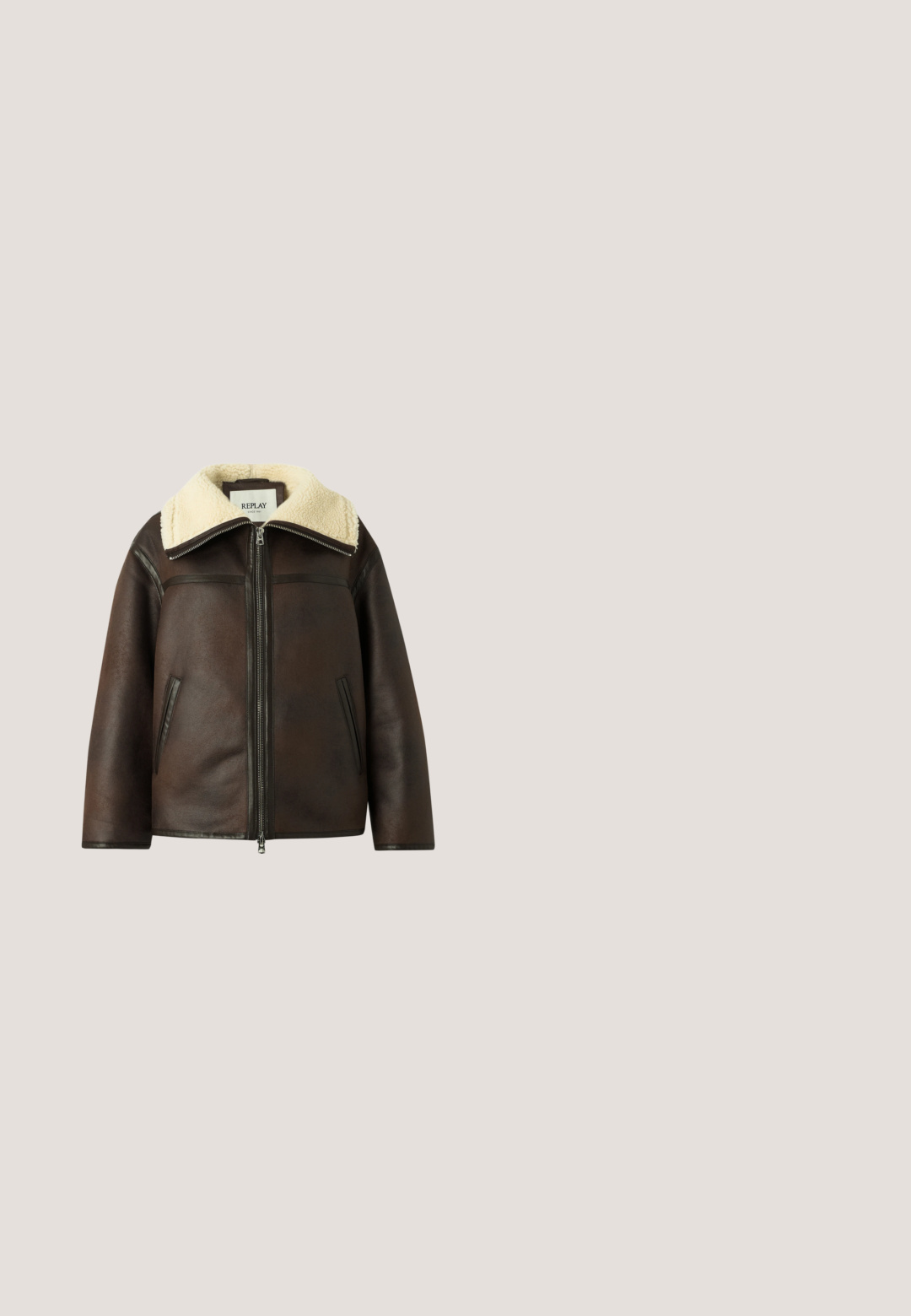Chaqueta de cuero marrón con cremallera frontal, bolsillos laterales inclinados y un gran cuello de borrego de color crema.; Suéter de manga larga acanalado en taupe claro, con un diseño ajustado, patrones texturizados y un pequeño logo en el dobladillo.; Vaqueros acampanados de color azul oscuro hechos de denim, con cintura alta, cinco bolsillos y costuras doradas. Los bajos son anchos y ligeramente deshilachados.; Botín negro de piel lisa con tacón cuadrado, que presenta un panel textil estampado con acentos dorados. El suelo es de madera texturizada y grava.; Bolso bandolera de cuero marrón oscuro con textura, correa ajustable, logotipo triangular de Guess y dos etiquetas de cuero colgantes en anillas doradas.; Guess MON AMOUR - Pendientes - yellow gold-coloured