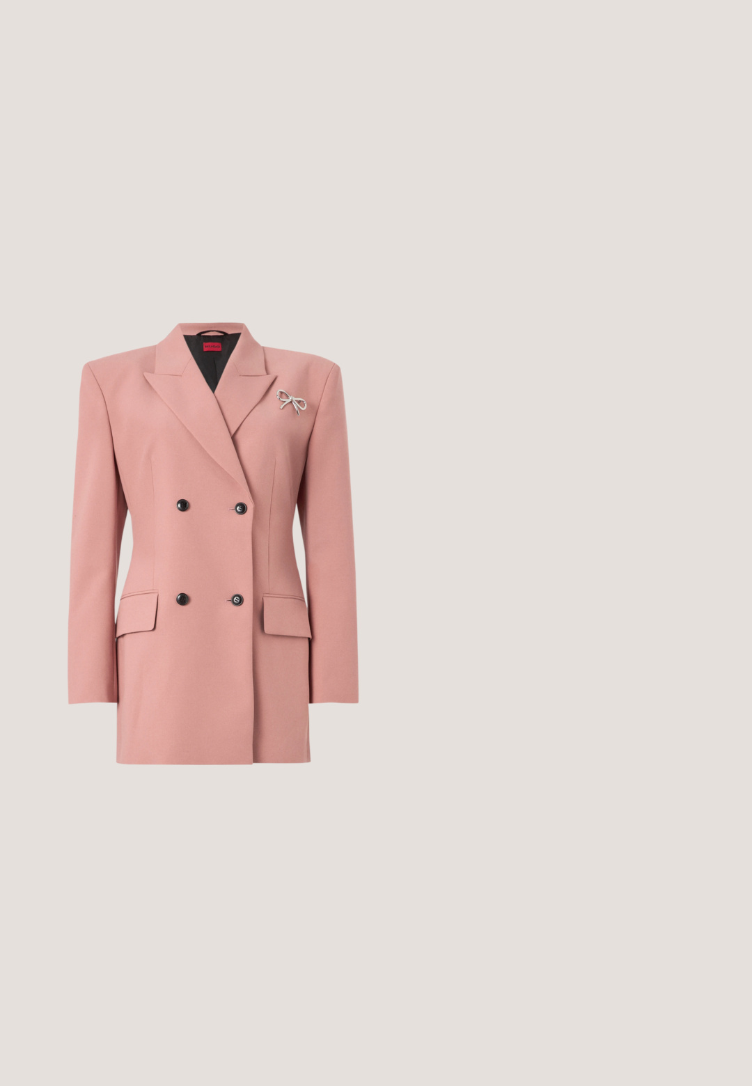Blazer de corte cruzado en suave tela rosa, con cuello de solapa, dos bolsillos frontales, botones negros y un adorno en forma de lazo plateado.; Top de tirantes rosa ajustado fabricado en tejido acanalado. Presenta tirantes ajustables y una pequeña etiqueta de logo marrón en la parte delantera. Textura suave.; Pantalones de campana negros hechos de una tela suave, con cintura alta, pliegues delanteros y un acabado limpio en los bajos.; Zapato de tacón alto negro con punta afilada y logo dorado, colocado sobre una superficie reflectante cerca de un organizador de archivos de alambre cromado con documentos.; Bolso de cuero negro texturizado con asas dobles, anillas doradas, placa con el logo de Hugo, correa de hombro ajustable y charm dorado en forma de corazón.; Pendientes de gancho de oro con grandes piedras preciosas rosas en forma de lágrima y pequeñas piedras redondas y transparentes encima de las gotas sobre un fondo liso.