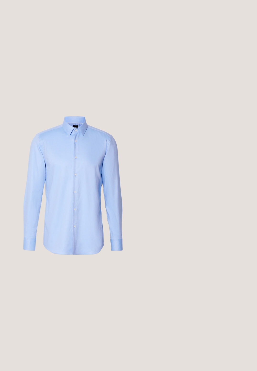 Camisa de botones de manga larga color azul claro, hecha de tejido texturizado, con cuello puntiagudo y cierre de botones clásico en la parte delantera.; Pantalones ajustados de color azul claro con una textura de tela suave, con un frentel plano, dos bolsillos frontales y un diseño de corte slim.; Zapato de vestir negro de cuero pulido con cordones flotando sobre una alfombra beige, con una gran mesa de cristal redonda de color ámbar al fondo.; Corbata azul marino con pequeños lunares blancos, colocada plana sobre un fondo claro, extremo estrecho en la parte superior y extremo ancho en la parte inferior.; Bolso de cuero negro con superficie texturizada, dos asas y una correa para el hombro desmontable. Presenta cremalleras plateadas y elementos de diseño minimalistas.; Cinturón de cuero negro enrollado con una hebilla rectangular negra mate y un logotipo en relieve discreto sobre un fondo blanco.
