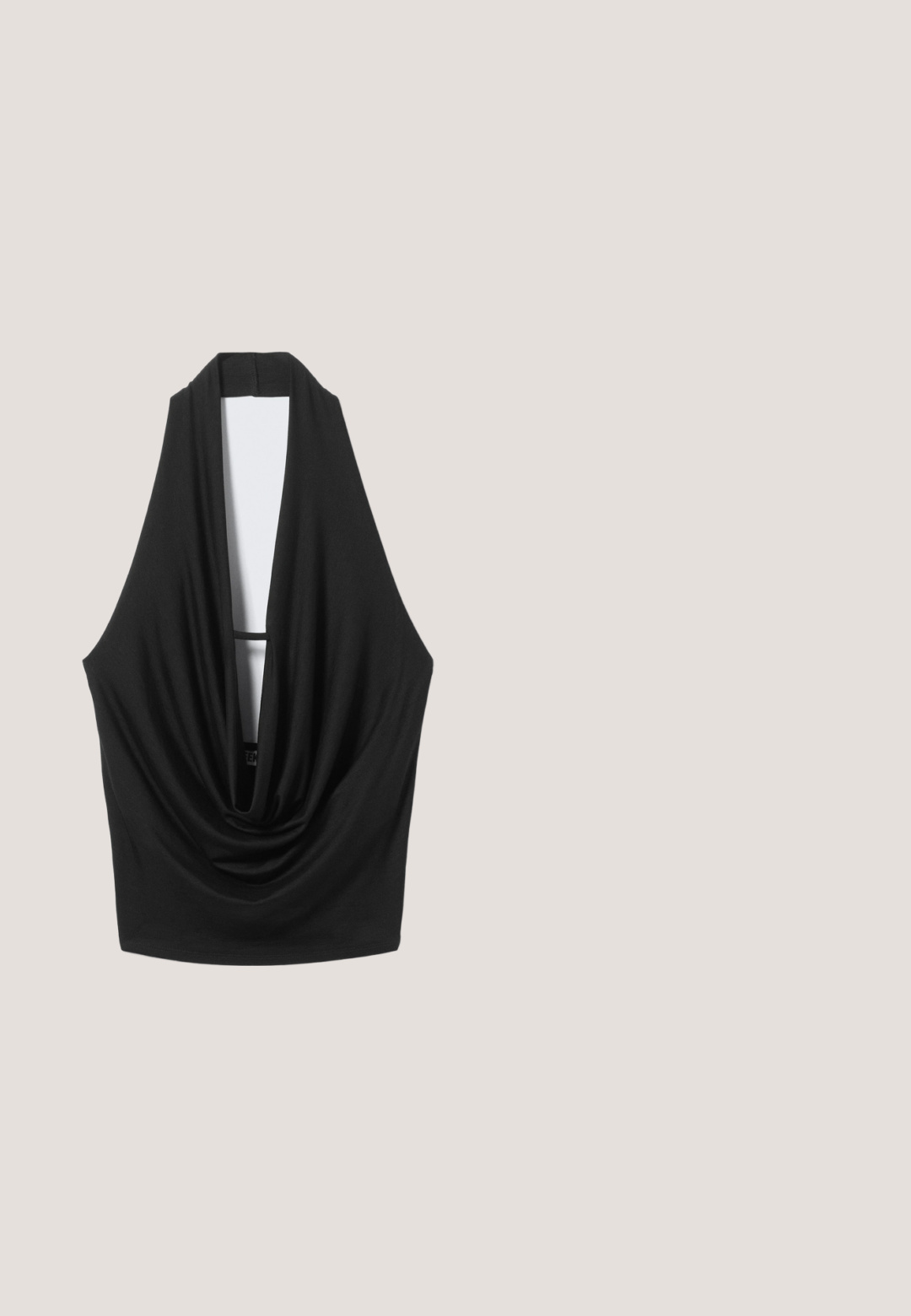 Black sleeveless halter top with deep draped neckline and open back, hanging against a light gray background.; Black faux leather flared jeans with front pockets, a metal button closure, and a slightly textured surface. Straight leg with a long cut.; Black slingback shoe with a pointed toe, featuring silver eyelets and a buckle accent. Made of textured material with a small block heel.; Black oval Vogue sunglasses with dark tinted lenses and glossy frames resting on a white surface.; Black synthetic leather handbag featuring a curved design, zippered front pocket, and decorative hardware with a detachable round coin pouch.; Black leather belt featuring a large silver metal buckle with intricate detailing and decorative accents on both ends.