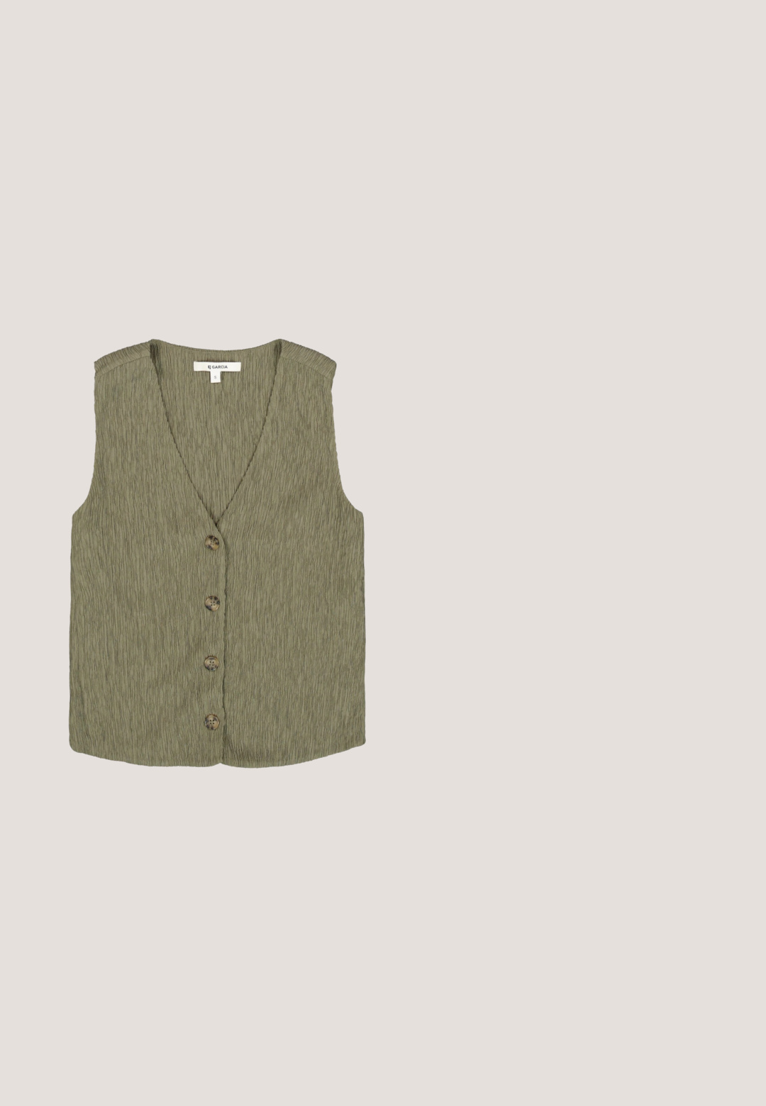 Mouwloze olijfgroene textuur gilet met V-hals en vier bruine knopen aan de voorkant, maat small van het merk Garcia.; Mouwloos cropped top met brede verticale strepen in afwisselend licht- en donkergroene linnenstof, met een ronde halslijn.; Lichtgroene broek met wijde pijpen, een elastische tailleband en zijzakken, gemaakt van zachte, luchtige stof.; Groene suede klomp met een brede band en metalen gesp, kurken voetbed en een rubberen zool. Beschikt over een klein ventilatiegaatje op de bovenkant.; Rechthoekige zonnebril met schildpad- en zwart montuur, donkere verloopglazen en een klein decoratief logo op het pootje.; Lichtgroene suède totebag met lange hengsels en een klein voorvakje met drukknoopsluiting.