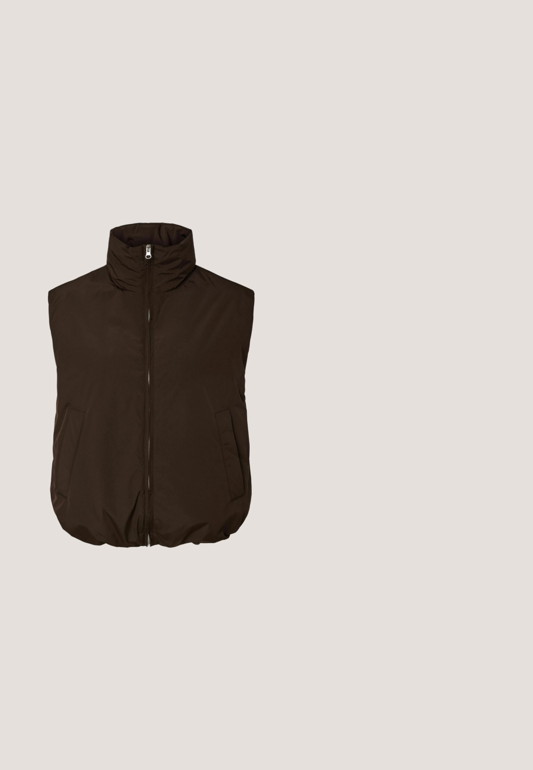 Ærmeløs mørkebrun vatteret vest med høj krave, lynlås foran og to sidelommer, vist på hvid baggrund.; Brun cropped sweatshirt med høj hals. Lavet af blødt stof, med lange ærmer og ribbekant på ærmer og bund. Glat tekstur, minimalistisk design.; Brune vidde bukser med elastisk talje, lavet af blødt, flydende stof, vist mod en hvid baggrund.; Platform sneakers med et brunt og cremefarvet camouflage-mønster, kontrasterende lysebrune såler og hvide snørebånd. Overdelen har blandede materialer og teksturer.; Brune, rektangulære solbriller med en gennemsigtig ramme, slanke tempelstænger og tonede linser, der har en glat tekstur og et moderne design.; Lille mørkebrun håndtaske i laklæder med to forlommer med klap og dobbelte skulderremme, stående på en hvid overflade.