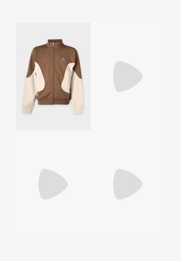 Brown and beige zip-up jacket with high collar and logo on the left chest, featuring curved beige panels on the front and sleeves.; Olive green oversized short-sleeve T-shirt with crew neck and small stitched logo on center chest.; Brown casual loose-fit pants with an elastic waistband and side pockets, featuring a small white logo on the right thigh.; Brown athletic shoe with white stripes and black laces floating above a concrete ledge with gray stairs in the background.