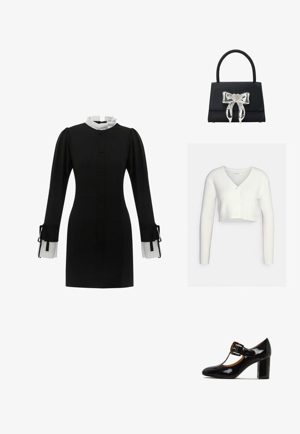 Hvid cropped cardigan lavet af tekstureret stof; har V-hals og tre knapper foran, med lange ærmer og en tætsiddende silhuet.; Sort kjole med høj hvid krave, knappelukning foran og lange ærmer med plisserede hvide manchetter med snore. Glat stoftekstur.; Sorte laklæder højhælede sko med rund tå, T-strop design og en skildpaddemønstret spændeaccent på overdelen. Blokhæl.; Sort håndtaske med struktureret design, udstyret med en blank sølvsløjfe med et rhinestones hjerte i midten og et kort, afrundet håndtag.