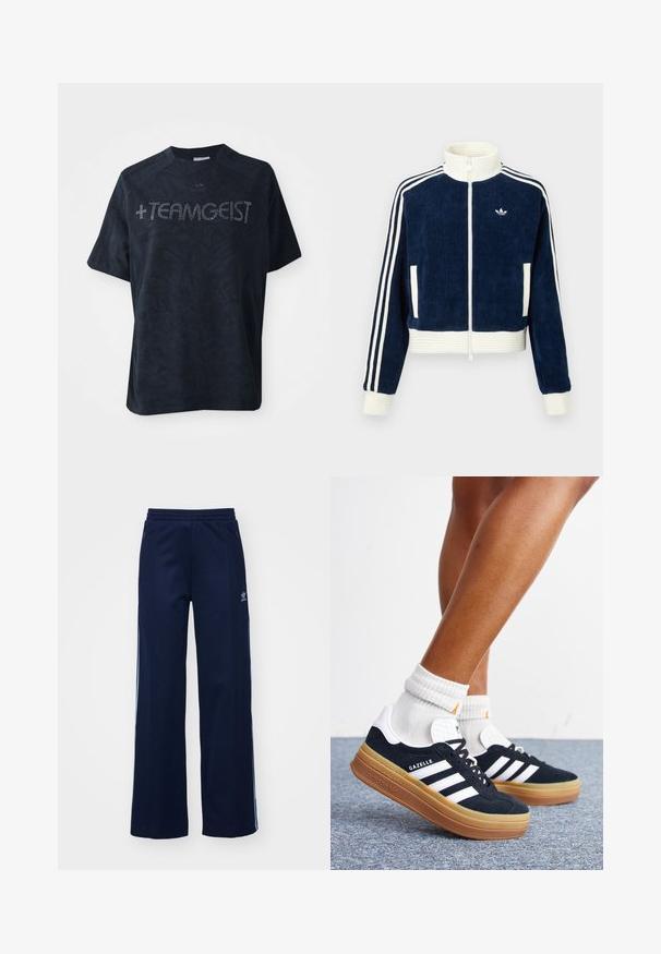 Marineblauwe corduroy ritsjack met witte geribde kraag en manchetten. Drie witte strepen op de mouwen en een klein logo op de borst. Twee voorzakken.; Zwarte korte mouwen t-shirt gemaakt van zachte stof, met een gestructureerd patroon en versierd met rhinestones die " +TEAMGEIST " spellen.; Marineblauwe katoenen joggingsbroek met een brede pijpdesign, elastische tailleband en ritszakken, voorzien van witte zijstrepen en logo-detail.; Ben met witte sokken en zwarte Adidas Gazelle sneakers met witte strepen en dikke bruine zolen op een grijs tapijt.