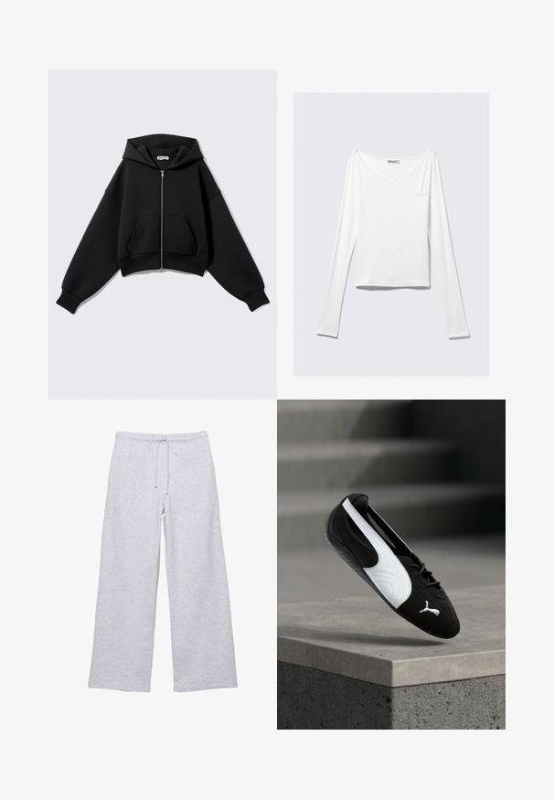 Sweat à capuche noir court en tissu doux, doté d'une fermeture éclair frontale, de grandes poches, d'une capuche et de manches oversize pour une coupe décontractée.; Haut blanc à manches longues avec un design croisé et une poche. Fabriqué dans un tissu lisse et extensible. Coupé dans une coupe décontractée et ample.; Pantalons de survêtement gris clair en tissu doux, avec une taille élastique et un cordon de serrage, des jambes larges et une texture lisse.; Baskets Puma noir et blanc avec lacets flottant au-dessus d'un rebord en béton sur un fond flou d'escaliers gris.