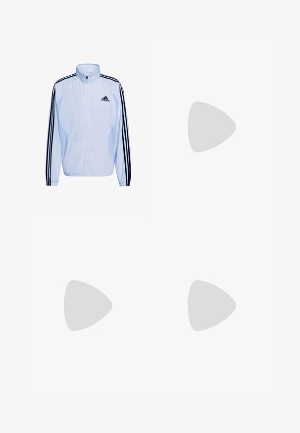 Biela športová bunda s tmavomodrým dizajnom troch pruhov na rukávoch, vysokým golierom, zapínaním na zips a ľahkým materiálom. S logom Adidas.; Svetlomodré polo tričko s dlhým rukávom, čiernym golierom, tromi čiernymi pruhmi na rukávoch a malým čiernym logom na hrudi.; Svetlomodré športové šortky s elastickým pásom, s čiernymi bočnými pruhmi a vyšitým čiernym logom na dolnom pravom rohu.; Čierna teniska Adidas Spezial s modrými a ružovými pruhmi, vznáša sa nad textúrovaným sivým betónovým povrchom so tieňom pod ňou.