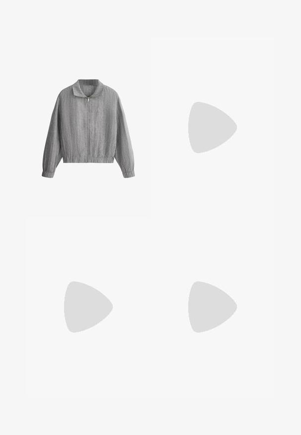 Veste grise zippée avec fines rayures blanches verticales, col montant, manches longues et poignets et ourlet élastiqués.; T-shirt blanc à manches courtes en coton doux, avec un col rond et une coupe ajustée. Pas de motifs ni d'ornements visibles.; Jean en denim gris vu de dos avec deux poches arrière, passants de ceinture et une coupe légèrement fuselée.; Baskets Adidas Spezial blanches avec des rayures noires et une semelle en gomme flottant au-dessus de marches en pierre grises à l'extérieur.