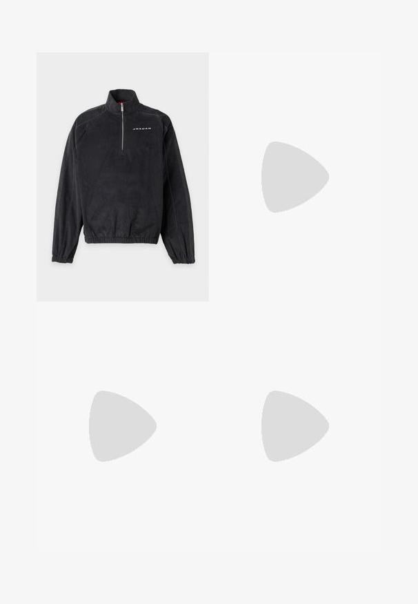 Pull en velours côtelé noir avec une fermeture éclair au quart, des poignets et un ourlet élastiques, et le mot "Jordan" imprimé sur le haut gauche de la poitrine.; T-shirt en coton bleu clair à manches courtes, col rond, avec un petit logo blanc sur la partie supérieure gauche de la poitrine. Texture douce, coupe décontractée.; Pantalon de survêtement gris avec une ceinture élastique, des poches latérales et des ourlets zippés, fabriqué en textile doux avec une texture lisse. Détail de logo subtil.; Baskets Adidas noires avec des rayures blanches, des lacets bleus et une semelle en gomme flottant au-dessus d'une marche en béton grise sous une lumière douce.