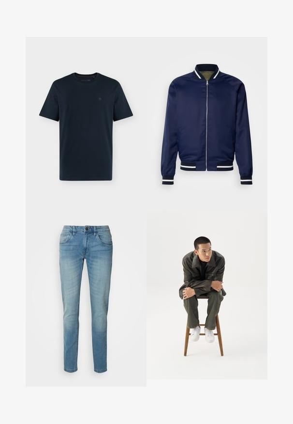 Chaqueta bomber de la marina hecha de un tejido suave; cuenta con puños y cuello a rayas blancas y marinas, cierre frontal con cremallera y bolsillos laterales.; Camiseta azul marino oscuro de manga corta y cuello redondo, con un pequeño logo discreto en el pecho izquierdo sobre fondo blanco.; Vaqueros de mezclilla azul claro, de pierna recta, diseño de cinco bolsillos, con cierre de botón y un ligero desvanecimiento para textura y detalle.; Joven con chaqueta de cuero oscura y vaqueros sentado en un taburete de madera, inclinado hacia adelante con los brazos cruzados, mirando hacia un lado contra un fondo blanco.