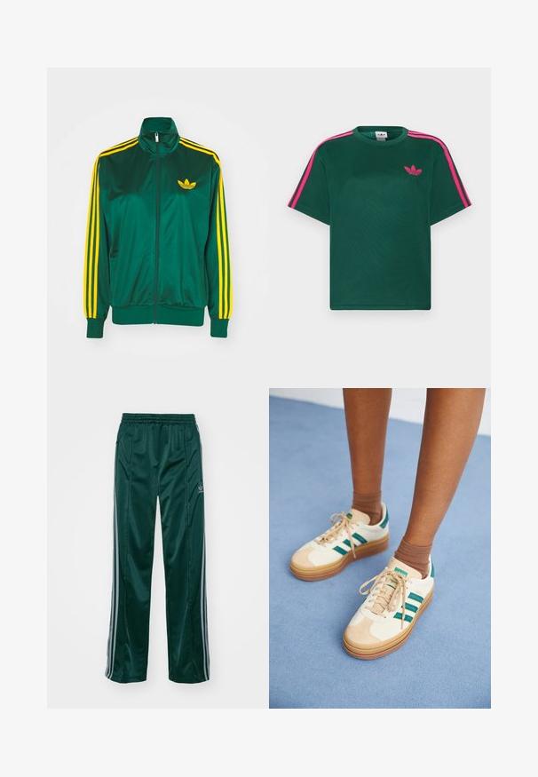 Grøn satin trackjakke, lynlåsfortil, høj krave, gul tre-stripes design på ærmerne og et lille gult logo på brystet.; Grøn kortærmet t-shirt med lyserøde striber på skuldrene og Adidas trefoil-logo på brystet.; Mørkegrønne træningsbukser lavet af skinnende materiale, med sidelister i lys grå og et broderet logo på venstre ben.; Beige sneakers med mørkegrønne striber, gummisål, overdel i ruskind og tekstil samt neutralt hardware, parret med brune sokker på en lyseblå overflade.