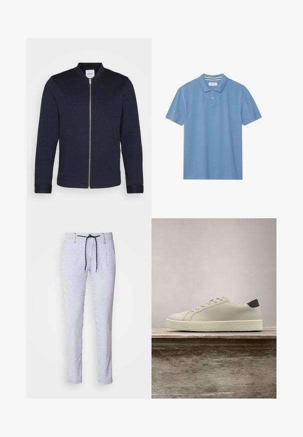Veste bomber bleu marine foncé avec une fermeture éclair sur le devant, un col rond et des manches resserrées. Fabriquée dans un tissu lisse avec un design minimaliste.; Polo bleu clair en tissu texturé, avec un col, une patte de boutonnage à trois boutons et des manches courtes.; Pantalons rayés en mélange de coton bleu clair et blanc, dotés d'une taille élastique avec cordon de serrage, de poches latérales et d'un design ajusté avec des jambes fuselées.; Baskets blanches avec semelle texturée et détail noir au talon, flottant au-dessus d'un banc en bois avec de hautes herbes vertes en arrière-plan.