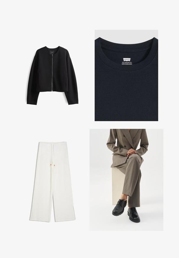 Zwarte cropped zip-up jas van soepel materiaal. Heeft een ronde halslijn, lange mouwen en zijzakken. Minimalistisch ontwerp.; Close-up van de halslijn van een zwarte Levi's T-shirt met het merklabel en tekst waarop staat San Francisco, Californië, gemaakt in Bangladesh.; Witte broek met wijde pijpen en een taillekoord voorzien van kleine kralen aan de uiteinden.; Persoon die een taupekleurig pak draagt en met gekruiste benen op een witte blok zit, zwarte leren veterschoenen toont tegen een witte achtergrond.