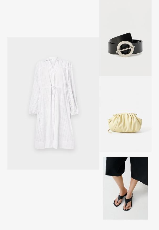Vestido blanco de manga larga con botones en la parte delantera, cintura con lazo, diseño de ojales y mangas fruncidas. Textura suave con un corte relajado.; Pies con sandalias de tacón negras de punta cuadrada y tiras anchas, combinadas con pantalones negros cortos sobre un suelo claro.; Bolso amarillo plisado hecho de cuero sintético suave, con una forma blanda y una sola correa para el hombro, además de un diseño de parte superior recogida.; Cinturón de piel sintética negra con una hebilla redonda de metal plateado. Textura plana y lisa con un diseño limpio y sin patrones visibles.