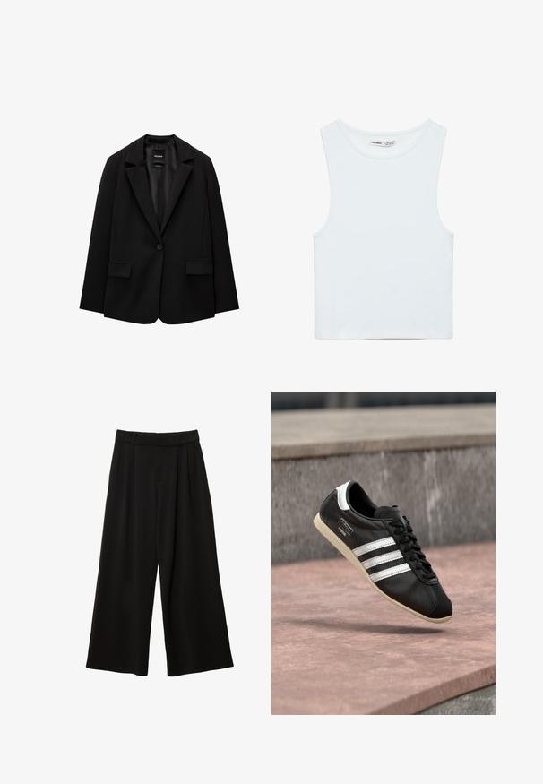 Blazer noir en tissu lisse avec une fermeture à bouton unique, des revers crantés et deux poches avant. Design minimaliste, coupe ajustée.; Crop top blanc sans manches avec col rond, en tissu lisse, étiqueté Pull&Bear, adapté pour un usage décontracté.; Pantalon noir à jambes larges, taille haute, plis devant, passants pour ceinture et coupe décontractée.; Baskets en cuir noir avec des rayures blanches et une semelle blanche, lacées, flottant au-dessus d'une surface en béton rosée avec un mur en pierre grise en arrière-plan.