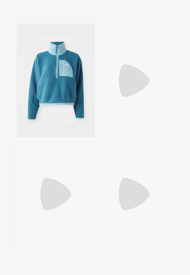 Blauer Fleece-Pullover mit einem Teilreißverschluss, hohem Kragen und einer Fronttasche. Akzentuiert mit einem helleren blauen Besatz und einer stofflichen Textur.; Weißes T-Shirt mit kurzen Ärmeln und kleinem blauem The North Face Logo auf der linken oberen Brust.; Schwarz lange Rock aus strapazierfähigem Stoff, mit einem flachen Bund und einer Schnalle sowie seitlichen Taschen. Logodetail auf der Vorderseite.; Hellbeige Ballettschuhe mit runder Zehenpartie, Schnürung am Knöchel, strukturiertem Obermaterial und flexibler Sohle. Eignet sich für die Freizeit.