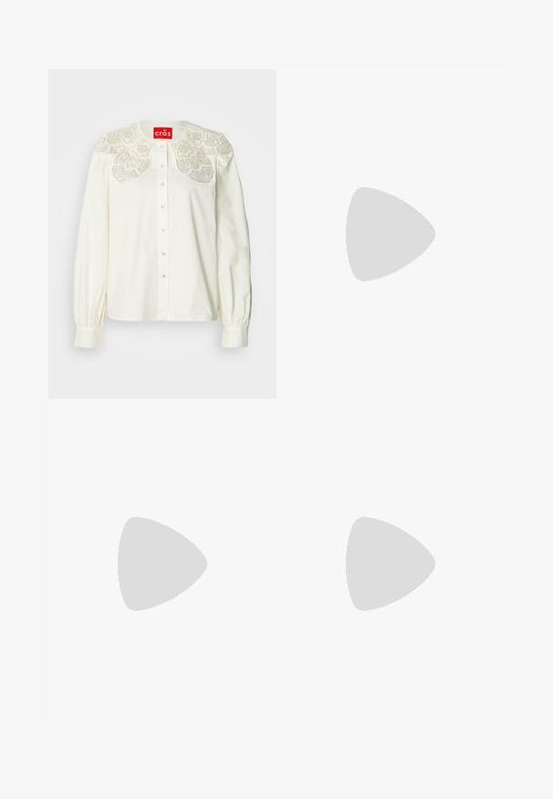 Chemise blanche boutonnée avec col en dentelle brodée décorative. Présente des manches longues avec poignets froncés et une coupe décontractée.; Jupe midi plissée noire avec taille haute, en tissu léger, suspendue à plat sur un fond blanc.; Jambes portant des leggings côtelés foncés associés à des ballerines noires avec de petits détails en nœud sur fond blanc.; Petit sac à main noir brillant avec deux longues anses et des détails à cordon sur les côtés sur un fond clair uni.