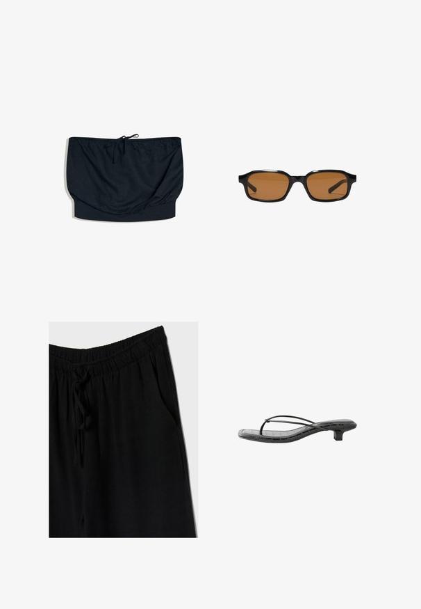 Haut bandeau noir sans bretelles avec un lien coulissant au centre et une large bande élastique en bas.; Pantalons noirs avec une taille élastique et un cordon de serrage, offrant une coupe décontractée et des poches latérales. Le matériau semble doux et léger.; Sandale noire à petit talon avec fines brides croisées et bout carré, avec un motif crocodile faux texturé sur la semelle.; Lunettes de soleil rectangulaires noires avec des montures épaisses et des verres teintés marron, vues de face sur un fond blanc.