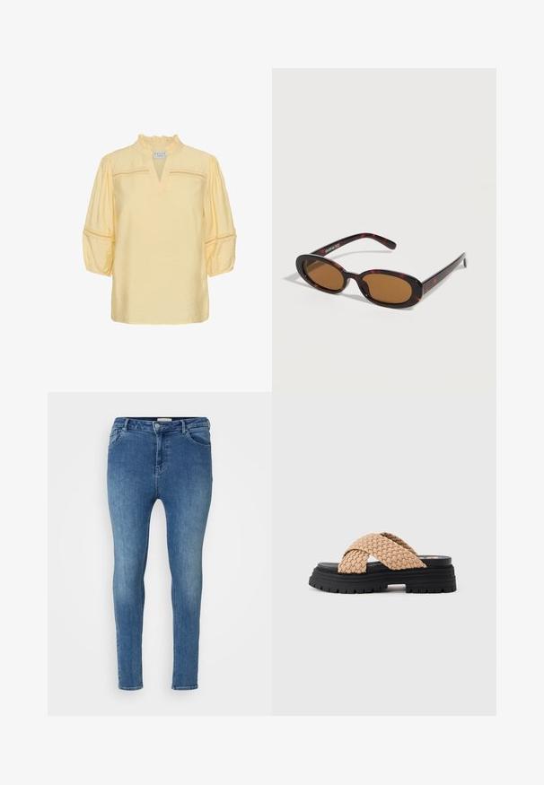 Gelbe Bluse mit gerafftem Kragen, V-Ausschnitt, dreiviertel-langen Puffsärmeln und Spitzendetails über Brust und Ärmeln.; Skinny Jeans aus hellblauem Denim mit glatter Textur. Sie verfügen über eine hohe Taille, Gürtelschlaufen und Fronttaschen. Klassisches Fünf-Taschen-Design.; Klobiger schwarzer Plateau-Sandale mit breiten, beigen geflochtenen Riemen, die den Fuß überschreiten, und einer strukturierten Sohle für besseren Halt.; Oval geformte Sonnenbrille im Schildpatt-Design mit braunen getönten Gläsern und dünnen Bügeln, liegend auf einer weißen Oberfläche.
