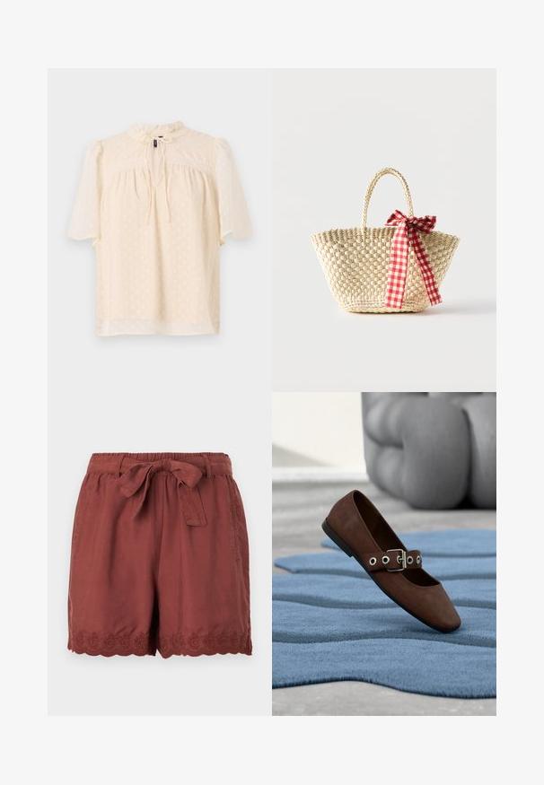 Lyse beige bluse med puffede ærmer, tekstureret stof med subtile prikker, nøglehulshalsudskæring med bånd og blondekant langs bærestykket.; Rustrøde shorts lavet af letvægtsstof, med en elastisk talje og snøring samt detaljeret bølget broderi ved kanten.; Brun ruskind flad sko med spænde-rem, der hviler på tekstureret blåt tæppe med gråt polstret møbel i baggrunden.; Flettet stråtaske med fletninger til håndtagene og et rødt og hvidternet bånd bundet som en sløjfe på den ene side.