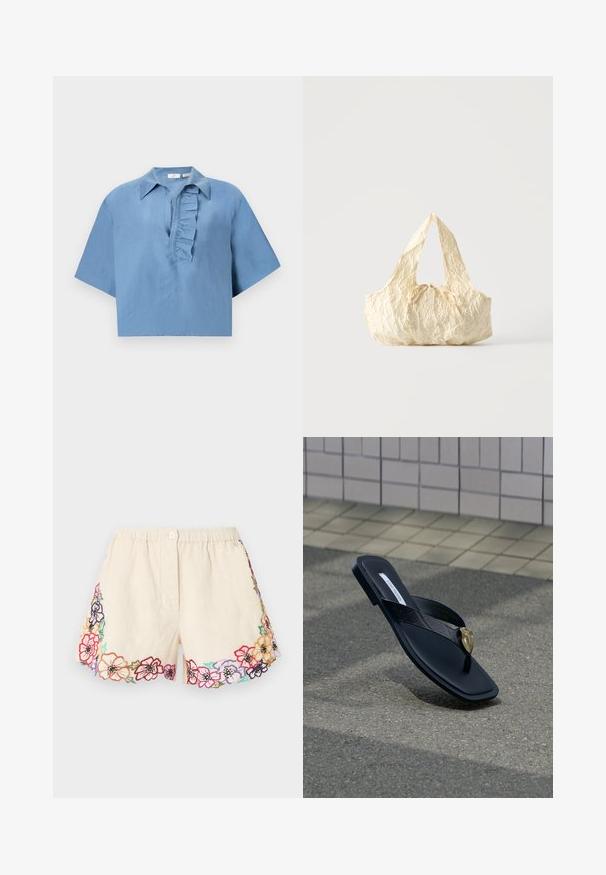 Chemise à manches courtes, bleue, en tissu lisse, avec un col boutonné et un plastron froncé à l'avant. Design court.; Shorts crème avec ceinture élastique, fermeture par bouton, et motifs floraux brodés multicolores le long de l'ourlet et des côtés.; Sandale tongs noire Steve Madden avec bride matelassée et décoration en forme de cœur doré, reposant sur l'asphalte près d'un mur carrelé.; Sac à main en tissu texturé couleur crème avec des anses sur le dessus et un petit nœud noué au centre devant.