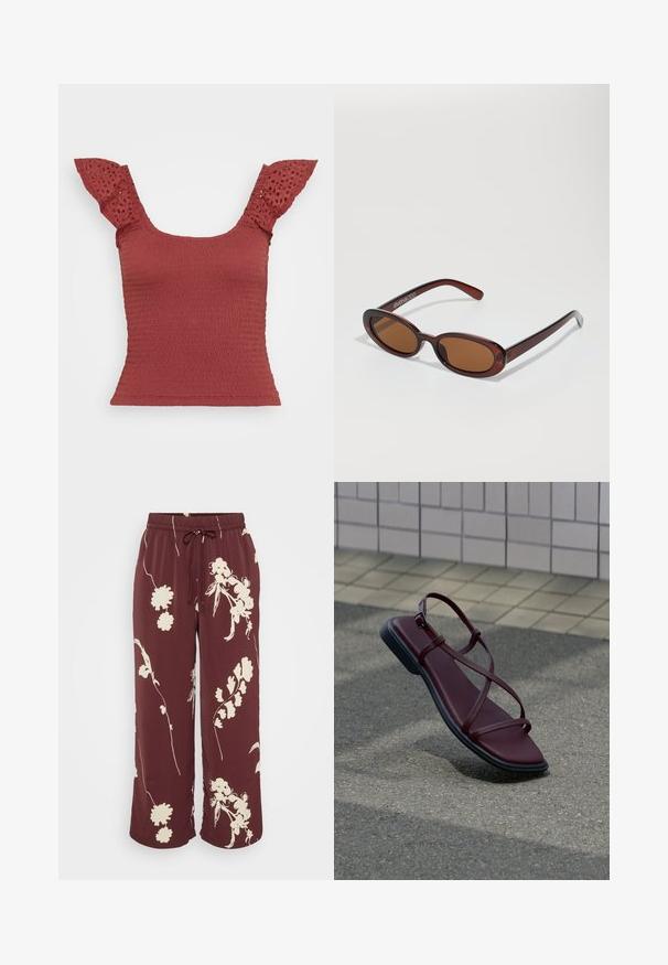 Haut smocké rouge avec des manches courtes à détail en œillet. Présente un décolleté carré et une silhouette ajustée, mettant en valeur un tissu texturé.; Pantalon large bourgogne en tissu lisse avec imprimé floral blanc, doté d'une taille élastique et d'un cordon de serrage pour un ajustement réglable.; Sandale en cuir rouge foncé avec des fines lanières croisées et une semelle noire posée sur un trottoir gris près d’un mur carrelé.; Lunettes de soleil rondes teinte brun avec une monture bordeaux brillante. Branches fines avec un détail de marque subtil. Design de verres plats.