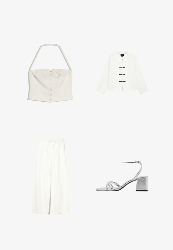Witte mouwloze crop top met halterneckband en rij knopen aan de voorkant, met een detail van een opgevouwen kraag.; Witte jas met lange mouwen, ronde kraag en vier zwarte horizontale frog-sluitingen aan de voorkant, getoond tegen een effen achtergrond.; Witte linnen broek met brede pijpen, elastische tailleband en trekkoord, voorzien van zijzakken en een voorste split.; Zilveren sandaal met blokhak, voorzien van dunne kruislingse banden en een verstelbare enkelband. Gladde metallic afwerking.