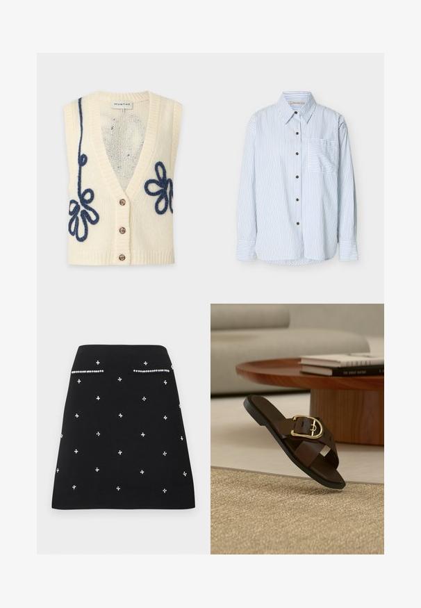 Veste sans manches en tricot crème avec trois boutons et broderie florale bouclée bleu foncé sur les côtés avant.; Chemise boutonnée à manches longues avec des rayures verticales bleues, une poche avant gauche à rayures horizontales et des boutons marron.; Jupe noire trapèze ornée de petites perles blanches et deux fausses poches avant soulignées de perles.; Sandale à enfiler en cuir marron avec boucle dorée sur un tapis beige, table basse en bois et livres en arrière-plan.