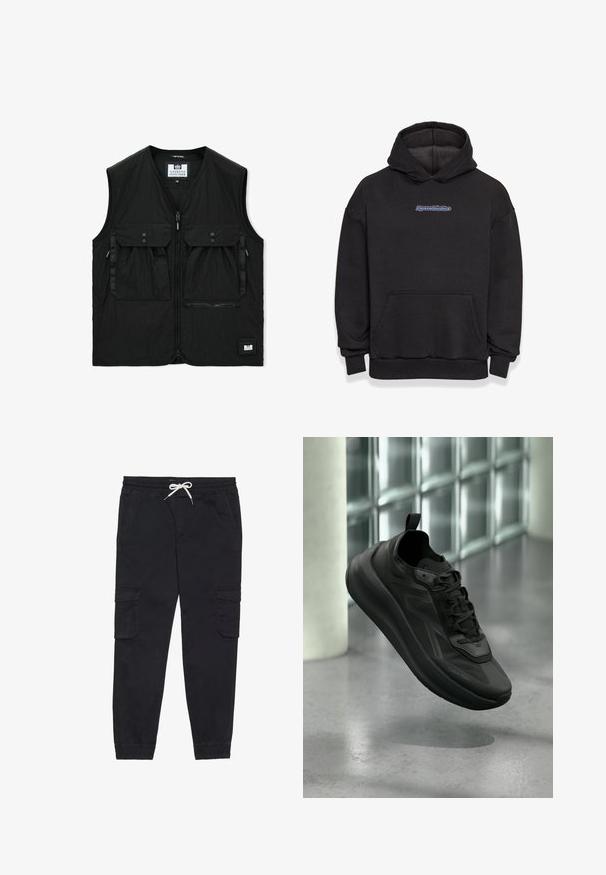 Veste noire sans manches avec fermeture éclair à l'avant, deux grandes poches à rabat avec boutons, une poche zippée et une petite étiquette logo à l'ourlet.; Sweatshirt à capuche noir en tissu en mélange de coton. Il comporte une poche frontale et un logo en bleu et rouge. Poignets et ourlet côtelés.; Pantalons cargo noirs en coton, avec une taille élastique et un cordon de serrage, des poches latérales et des poignets fuselés.; Baskets noires Calvin Klein avec lacets, surélevées au-dessus d'un sol en béton poli, mur en blocs de verre et pilier en arrière-plan flou.