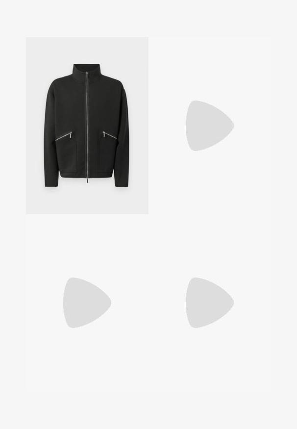 Black zip-up jacket with a high collar, featuring two front zip pockets and a relaxed fit. Smooth texture and minimalistic design.; White long-sleeve shirt made of linen. Features a pointed collar, full button front, and a small embroidered logo on the left chest.; Black pleated trousers with a straight, wide-leg design. Made from smooth fabric, featuring a button closure and belt loops.; Dark brown textured leather sneaker with lace-up front and white ridged rubber sole on a plain light background.