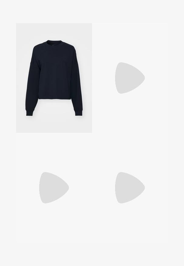 Navy blue sweatshirt with long sleeves, crew neck, and a cropped fit. Made of soft fabric with ribbed cuffs and hem.; Black cotton T-shirt featuring a graphic print in pink and white with the text "JUST DO IT," "NIKE," and "Athletic Depart." Standard fit.; Black athletic pants with a shiny, smooth fabric, featuring an elastic waistband, wide legs, and a small logo on the left side.; Black athletic sneakers with mesh upper, textured accents, and visible air cushioning pods in the sole. Worn with blue denim jeans.
