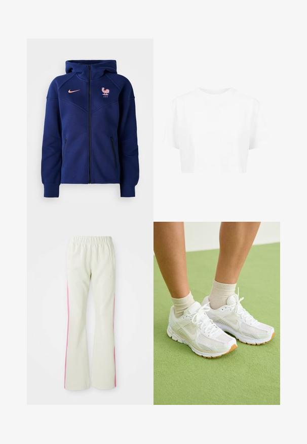 Marineblå hettejakke med glidelås laget av mykt stoff, har kengurulomme, fransk fotballmerke og Nike-logo i korall.; Hvit cropped t-skjorte, korte ermer, rund hals, laget av glatt stoff, uten synlige mønstre eller særegent tilbehør.; Lys beige bukser med elastisk linning, med rosa sidepaneler og sidelommer. Glatt tekstur med rett ben-design.; Hvite sportssko med mesh-stoff, gummisåler og beige detaljer. Brukt med lyse sokker på en grønn overflate.