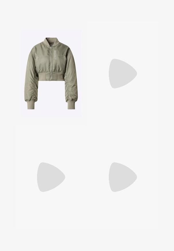 Cropped bomber jacket in olive green, featuring a zip front, ribbed cuffs, and a smooth, shiny texture with a patch on the left side.; Beige long-sleeve top with an off-the-shoulder design, featuring a ruched texture and a fitted silhouette. Smooth, stretchy fabric.; Wide-leg trousers made of smooth fabric, featuring a brown background with a black leopard print pattern and an elastic waistband.; Brown suede sneakers with white accents and laces. Rubber gum sole. Worn with white socks featuring black stripes. Green textured flooring.
