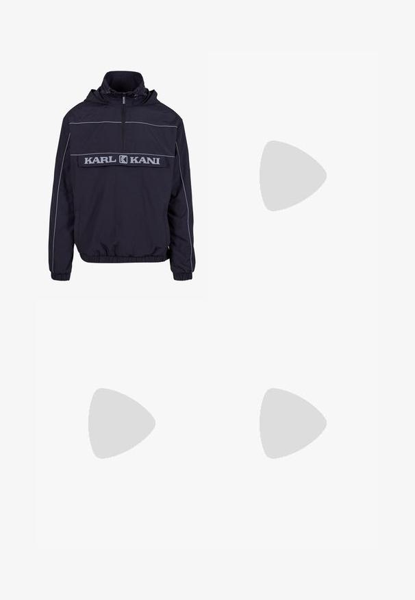 Black windbreaker jacket featuring a half-zip, kangaroo pocket, elastic cuffs, and contrasting grey piping with "KARL KANI" logo.; Gray cotton blend t-shirt with black Nike logo; features a small Nike label on the side hem; simple design, short sleeves.; Beige cargo pants in a lightweight cotton material. Features elastic cuffs, multiple side pockets, and a button closure.; White leather sneakers with perforations, round toe, flat sole, and thick laces, featuring a visible swoosh logo and "AIR" on the heel.