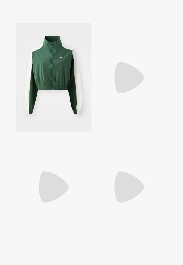 Green cropped jacket with a high collar, contrasting white sleeves, zipper closure, and an elastic waistband. Nike logo on the chest.; Cream short-sleeve T-shirt made of cotton, featuring a round neckline and a printed Nike logo in contrasting light grey on the chest.; White wide-leg athletic pants with a ribbed waistband and subtle logo detail. Smooth fabric with a relaxed fit and tapered hem.; White leather sneakers with yellow and lavender accents, round toe, flat laces, and textured rubber sole. Worn with white socks.
