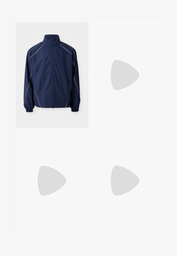 Navy windbreaker jacket, lightweight material, zip-front closure, high collar, elastic cuffs, and gray accent stitching along the seams.; Three white ribbed tank tops made of cotton. Features a crew neck and small black labels near the hem. Available in multiple sizes.; Black elastic-waist pants with a straight fit, made from smooth fabric, featuring elastic cuffs at the ankles and no visible pockets.; Black athletic shoes with a textured upper, white swoosh logo, padded heel, and a contrasting white sole featuring a zigzag pattern.