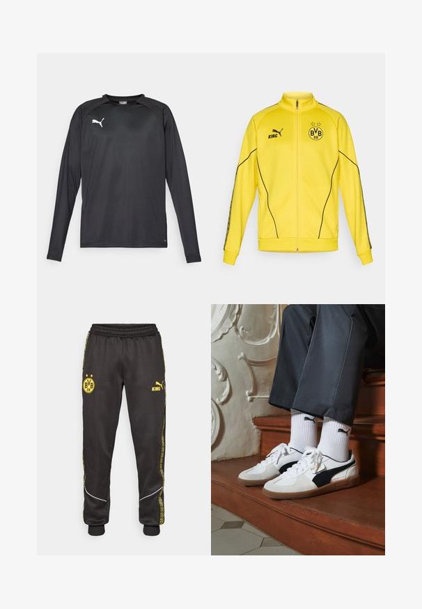 Giacca sportiva gialla con zip intera, logo Puma nero, testo "KING" ed emblema del club di calcio BVB 09 con due stelle sul petto.; Maglietta sportiva nera a maniche lunghe realizzata in tessuto leggero, dotata di collo tondo e di un logo bianco sul lato sinistro del petto. Texture liscia.; Pantaloni sportivi neri con loghi gialli di Borussia Dortmund BVB 09 e Puma King, vita elasticizzata e righe laterali gialle con motivo.; Sneakers Puma in suede bianco e nero, con suola in gomma marrone. Abbinati a calzini bianchi con logo nero, indossati con pantaloni scuri.