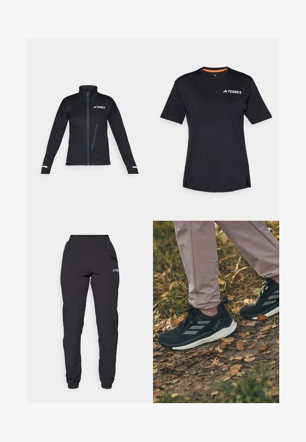 Sort softshell-jakke med høj krave, lynlåslukning foran, sidelomme, struktureret mønster på stoffet og reflekterende detaljer på ærmerne.; Sort kortærmet T-shirt med rund halsudskæring, der har en subtil meleret tekstur og hvid "TERREX"-logo på den øverste venstre side.; Sorte vandtætte bukser med elastisk talje, lynlåslommer på siderne, tapered ben og ribbede cuffs ved anklerne. Har logo detaljer.; Sorte sportssko med lysegrå striber, med en struktureret overdel, hvid støddæmpende sål, båret med lyserøde bukser, på et bladbeklædt underlag.