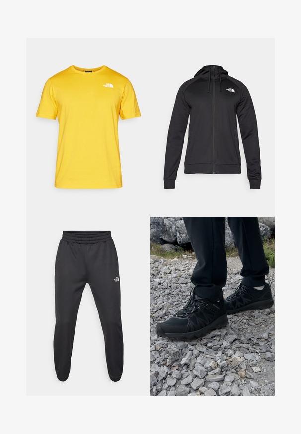 Sort zip-up hættetrøje med en tætsiddende pasform, der har snøre i hætten og logo på venstre bryst. Blødt, strækbart stof med ribbede manchetter.; Gul bomulds T-shirt med korte ærmer, rund halsudskæring og et hvidt logo på venstre bryst. Stoffet ser glat og let ud.; Sorte sweatpants med snor i livet, tætsiddende pasform, elastiske manchetter og et lille hvidt logo på venstre lår, lavet af glat stof.; Sorte udendørssko med mesh og syntetisk materiale, med en tekstureret overdel, sikre snørebånd og en robust ydersål, på klippelandskab.