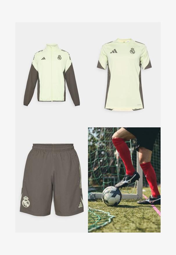 Bunda Adidas s tělem v světle zelené barvě a tmavě hnědými rukávy. Obsahuje vysoký límec, přední zip a logo na hrudi.; Světle zelené tričko s krátkým rukávem a tmavě šedými akcenty, s týmovým logem na hrudi, vyrobené z prodyšného materiálu s technologií odvodu vlhkosti.; Šedé sportovní šortky s elastickým pasem, světlé zelené boční pruhy a bílé logo Real Madrid na levém lemu.; Černé fotbalové kopačky se stříbrnými akcenty na travnatém hřišti, červené ponožky a fotbalový míč v černobílé barvě umístěný pod nohou.