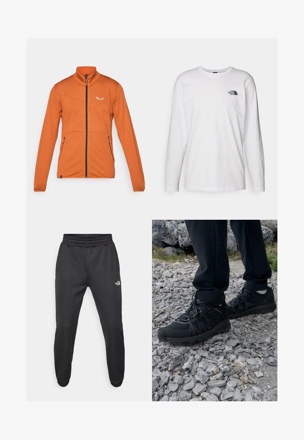Præstationsjakke i orange stof med lynlås, høj krave og to lynlåslommer på siden. Har tekstureret mønster og logo detaljer.; Hvid langærmet T-shirt lavet af bomuld med rund hals. Har et lille sort logo på brystet. Glat tekstur, almindelig pasform.; Sorte sweatpants med snor i livet, tætsiddende pasform, elastiske manchetter og et lille hvidt logo på venstre lår, lavet af glat stof.; Sorte udendørssko med mesh og syntetisk materiale, med en tekstureret overdel, sikre snørebånd og en robust ydersål, på klippelandskab.