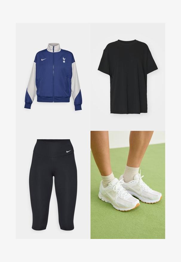 Veste zippée bleu marine avec des manches grises, dotée d'un col haut, du logo Nike et de l'emblème de Tottenham Hotspur. Fabriquée en tissu lisse.; T-shirt noir à manches courtes en tissu lisse, avec un col ras du cou et une coupe décontractée. Présente des fentes sur les côtés pour plus de confort et de respirabilité.; Les leggings capri noirs Nike présentent une taille haute, un tissu extensible lisse et un détail de logo discret à l'avant.; Baskets blanches en tissu maillé, avec des semelles en caoutchouc et des détails beiges. Portées avec des chaussettes claires sur une surface verte.