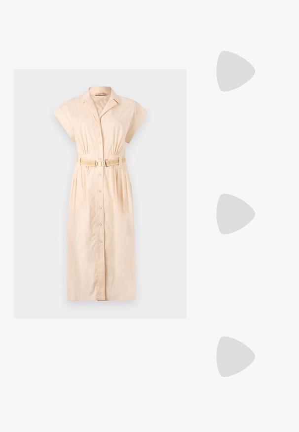 Girlfriend Collective FLOAT ZOE TANK CROSS BACK - Top - chinoiserie; Light peach shirt dress made of cotton with a collar, short sleeves, front button closure, and a braided belt at the waist.; Gray pinstriped wide-leg trousers with a smooth texture, paired with black leather flats featuring a rounded toe.; Gold chain-link earrings featuring a clear crystal-accented design, with engraved "GUESS" branding and a smooth finish.