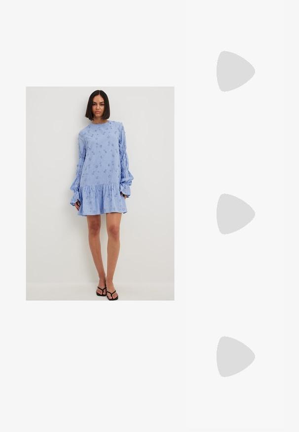 Light blue, long-sleeve dress with textured floral embroidery, ruffled hem, and voluminous sleeves. Made of a lightweight fabric.; Silver slingback high heel shoe with a pointed toe, metallic finish, two decorative straps, and a slender heel with a black tip.; Silver metallic heart-shaped handbag with dual handles, chain strap, and smooth texture. Features metal hardware and stitched edges.; Set of 16 silver bangles with various textures, including smooth, twisted, and beaded patterns, arranged in four rows on a white background.