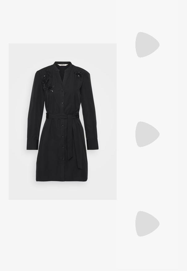 Abito camicia nero in cotone con cintura in vita, chiusura frontale a bottoni e dettagli floreali in paillettes sulle spalle.; Sandali neri flat con cinturini intrecciati, dettagli in tonalità oro e un design minimalista caratterizzato da una suola sottile e una fibbia regolabile alla caviglia.; Occhiali da sole neri a forma di occhio di gatto con finitura opaca, dotati di lenti grigie, angoli acuti e stanghette slanciate. Nome del marchio visibile all'interno della stanghetta.; Orecchini a cerchio in oro con una finitura liscia e lucida. Design circolare con un piccolo perno e una chiusura trasparente per un indosso sicuro.
