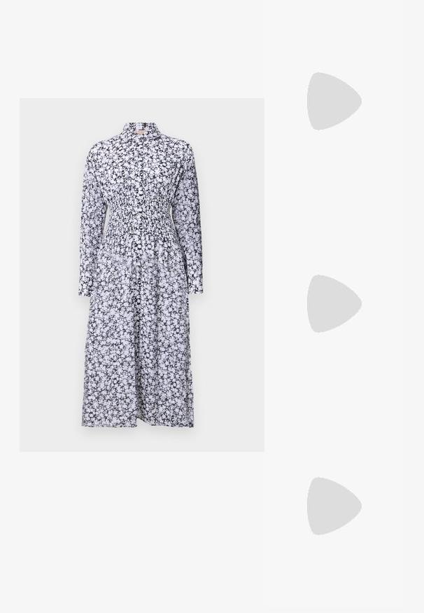 Robe à imprimé floral noir et blanc avec un col, des manches longues, une taille smockée et une jupe fluide. Fabriquée dans un tissu léger.; Débardeur blanc sans manches en tissu doux et côtelé ; présente des bretelles fines et un col rond, l'étiquette indique "FRAME."; Ballerines noires avec lanière de cheville réglable, ornées de clous en argent, en tissu texturé, à bout rond, avec un petit nœud sur le devant.; Sac à main en cuir noir avec un design structuré, deux poignées supérieures, une bandoulière amovible, des accessoires en or et un pendentif avec le logo.