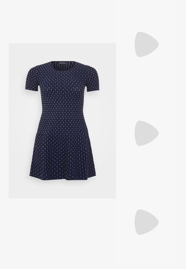 Navy blue short-sleeved dress with a ribbed texture, featuring white polka dots in vertical lines and a flared skirt design.; White leather sneakers, low-top design, featuring a smooth texture, round toe, laced front, and a small embroidered logo on the side.; Black leather half-moon bag with a gold hardware accent, featuring a zip closure. Worn crossbody over a gray sweater.; Gold-tone knot stud earrings with a twisted design. Each earring features a circular clear backing for secure wear.