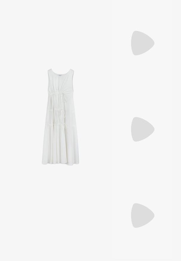 Vestido blanco sin mangas con escote redondo, detalle fruncido en la cintura y falda fluida. Hecho de una tela suave y ligera.; Zapatos de tacón en charol negro con tira al tobillo, punta afilada y un pequeño tacón bloque, que cuentan con un acento de hebilla plateada en la correa.; Bolso cruzado de piel color beige con detalle de lazo, herrajes dorados y una sola correa ajustable, llevado sobre una chaqueta de lana acolchada verde.; Conjunto de seis anillos de oro con diversos diseños: trenzados, motivos de hojas y bandas sólidas; algunos con acentos de piedras preciosas verdes.